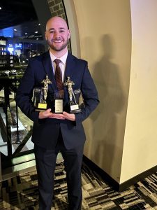 Hunter holding five awards